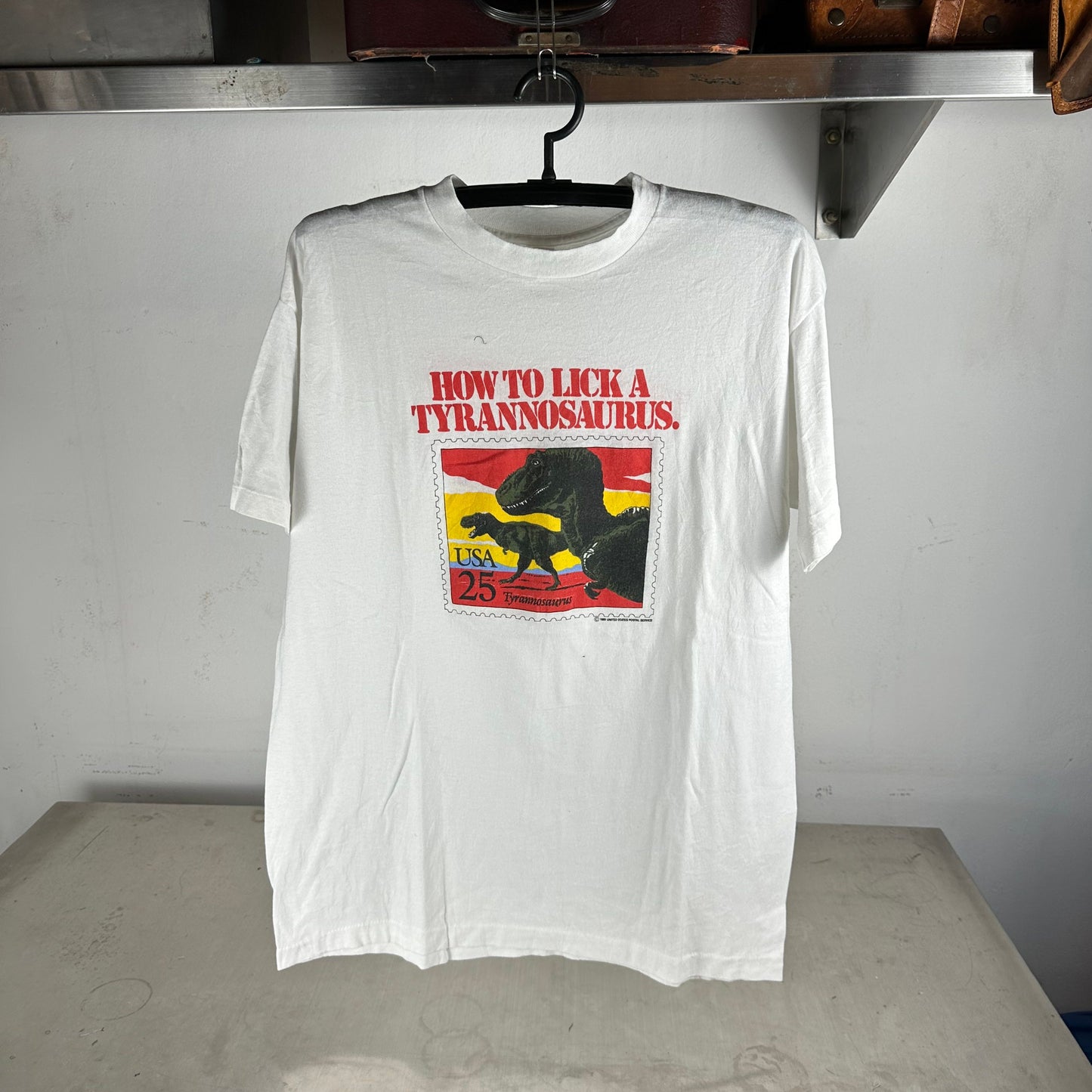 Vintage 1989 USPS How To Lick a Tyrannosaurus Stamps Graphic T-shirt