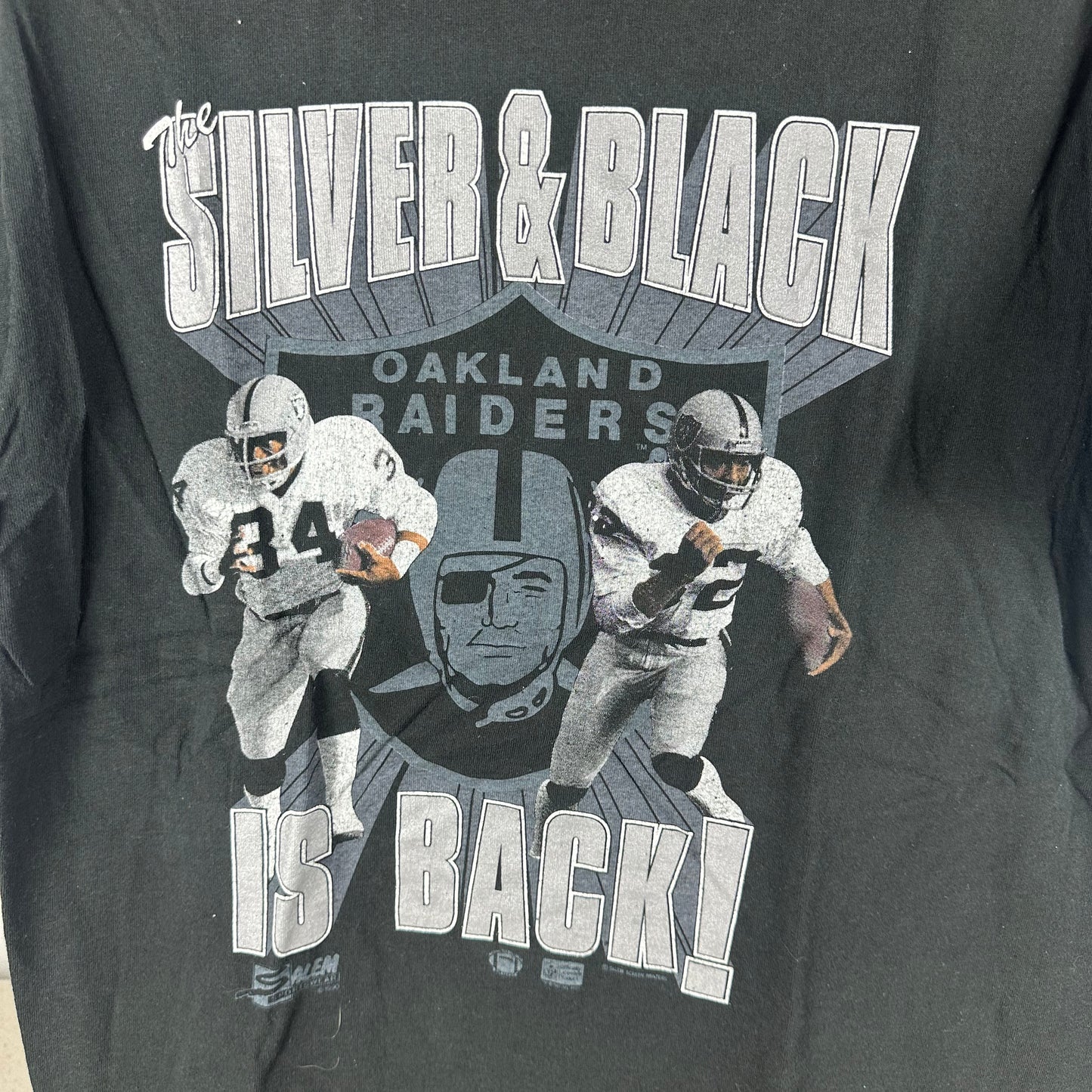 Vintage 1990 Oakland Raiders NFL The Silver &amp; Black is Back! T-shirt